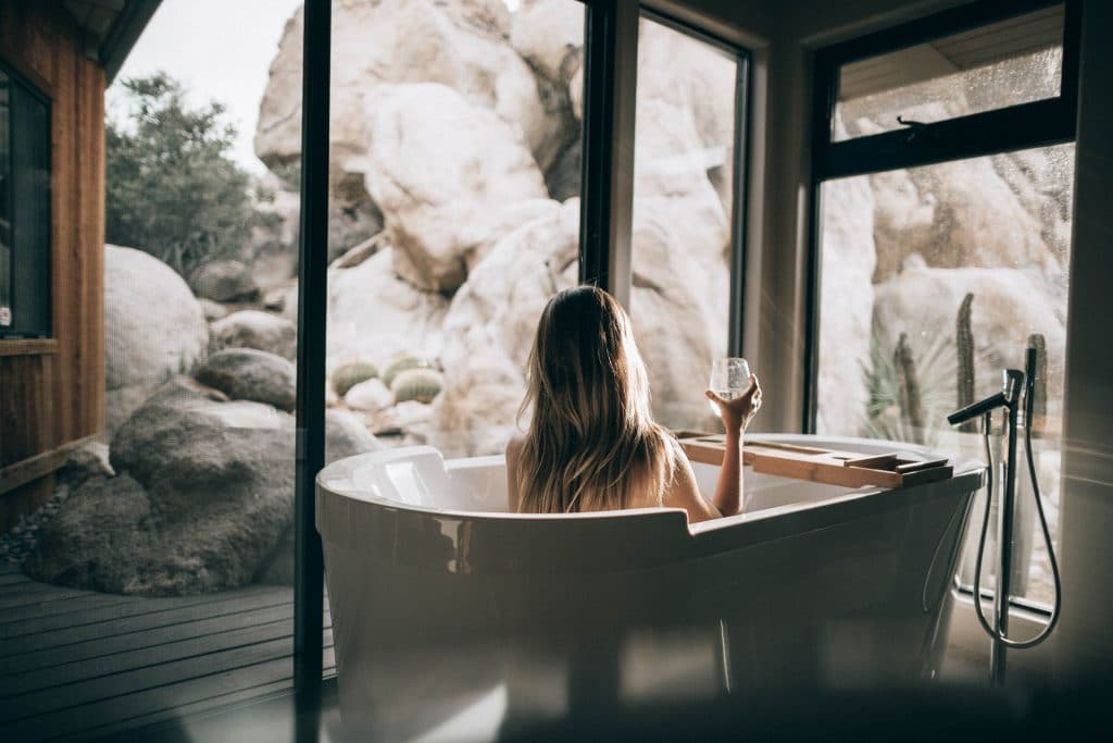 image of woman sitting in bath filled with hot water