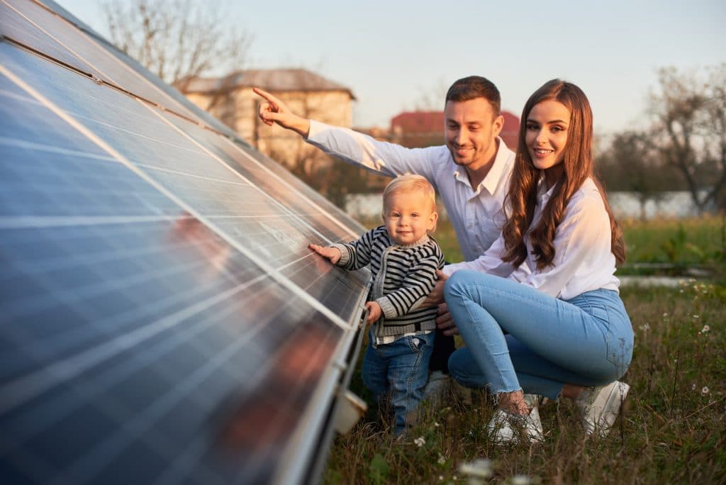 image of father showing his family a solar panel array